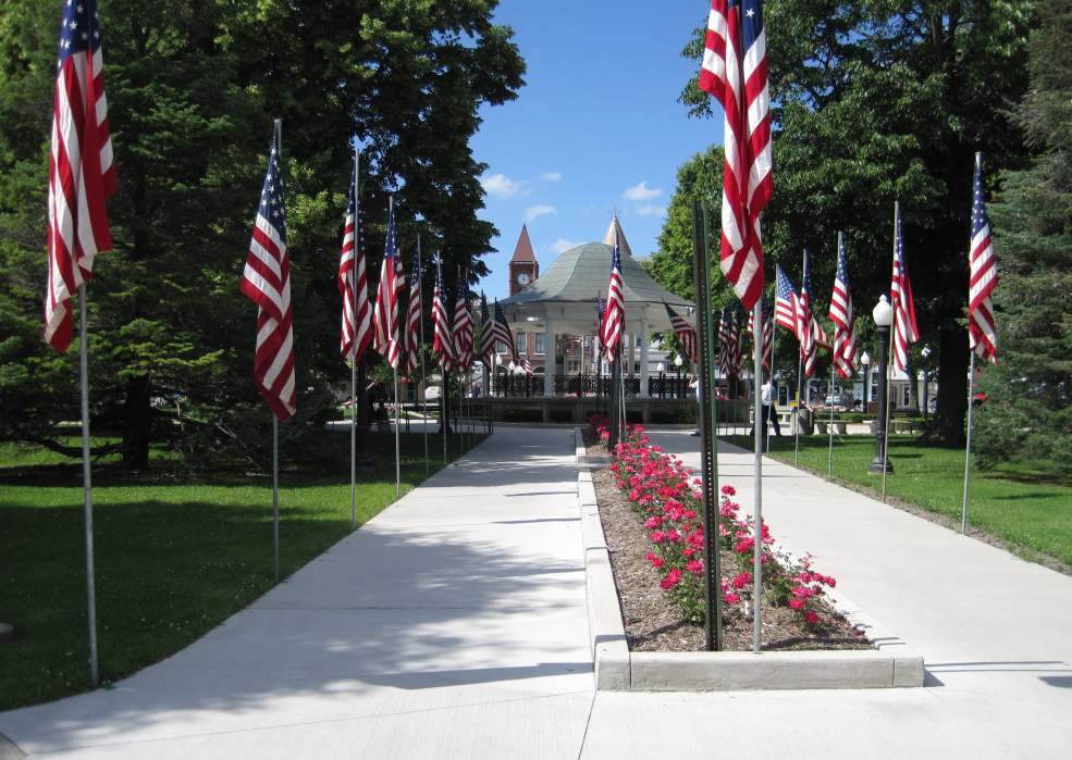 American flags fill the Square every Memorial Day.  The Courthouse steeple peeks over the bandstand.